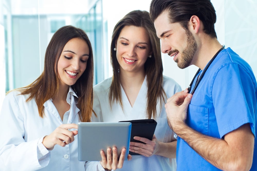 nurse practitioners looking at tablet
