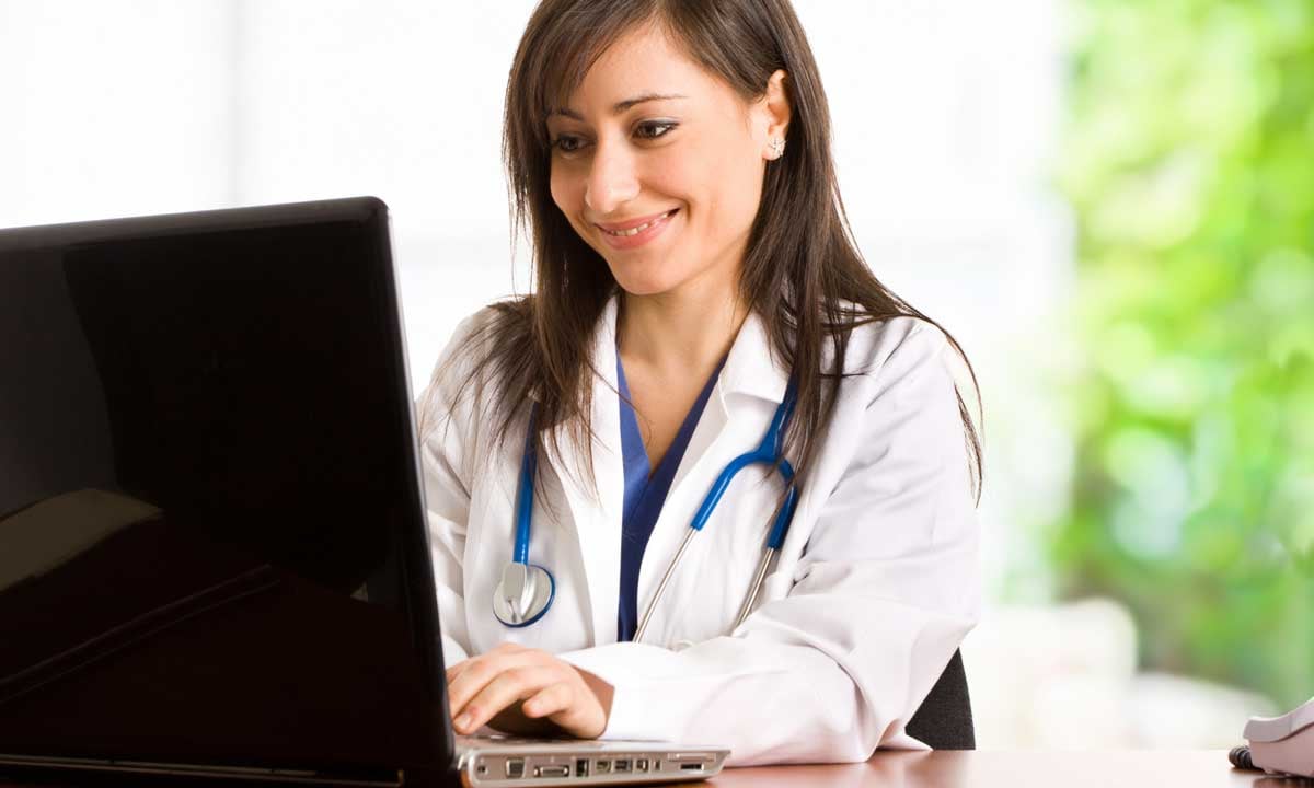 Female advanced practice provider at computer